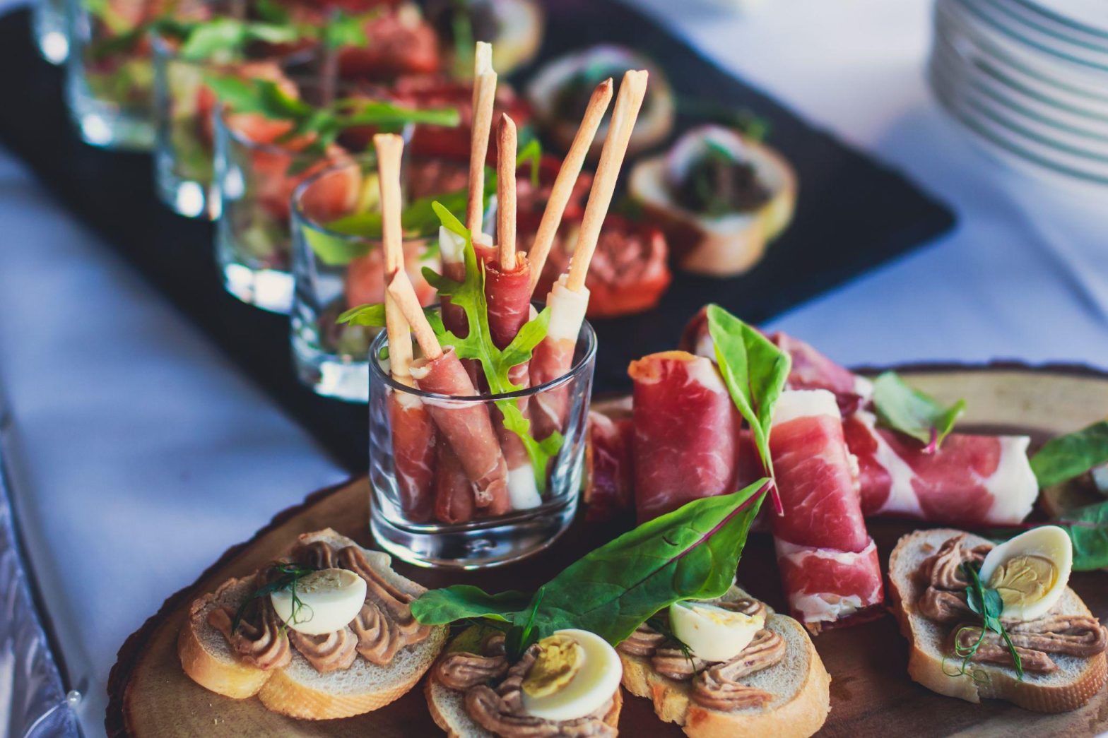 Elegant holiday appetizer display with prosciutto, crostini, and festive garnishes, representing Seattle holiday catering.