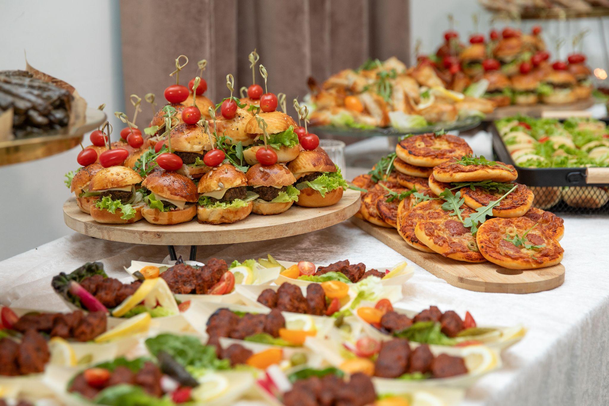 Holiday catering setup with gourmet sliders, mini pizzas, and appetizers, prepared by Chef Dane Catering for Seattle holiday events.