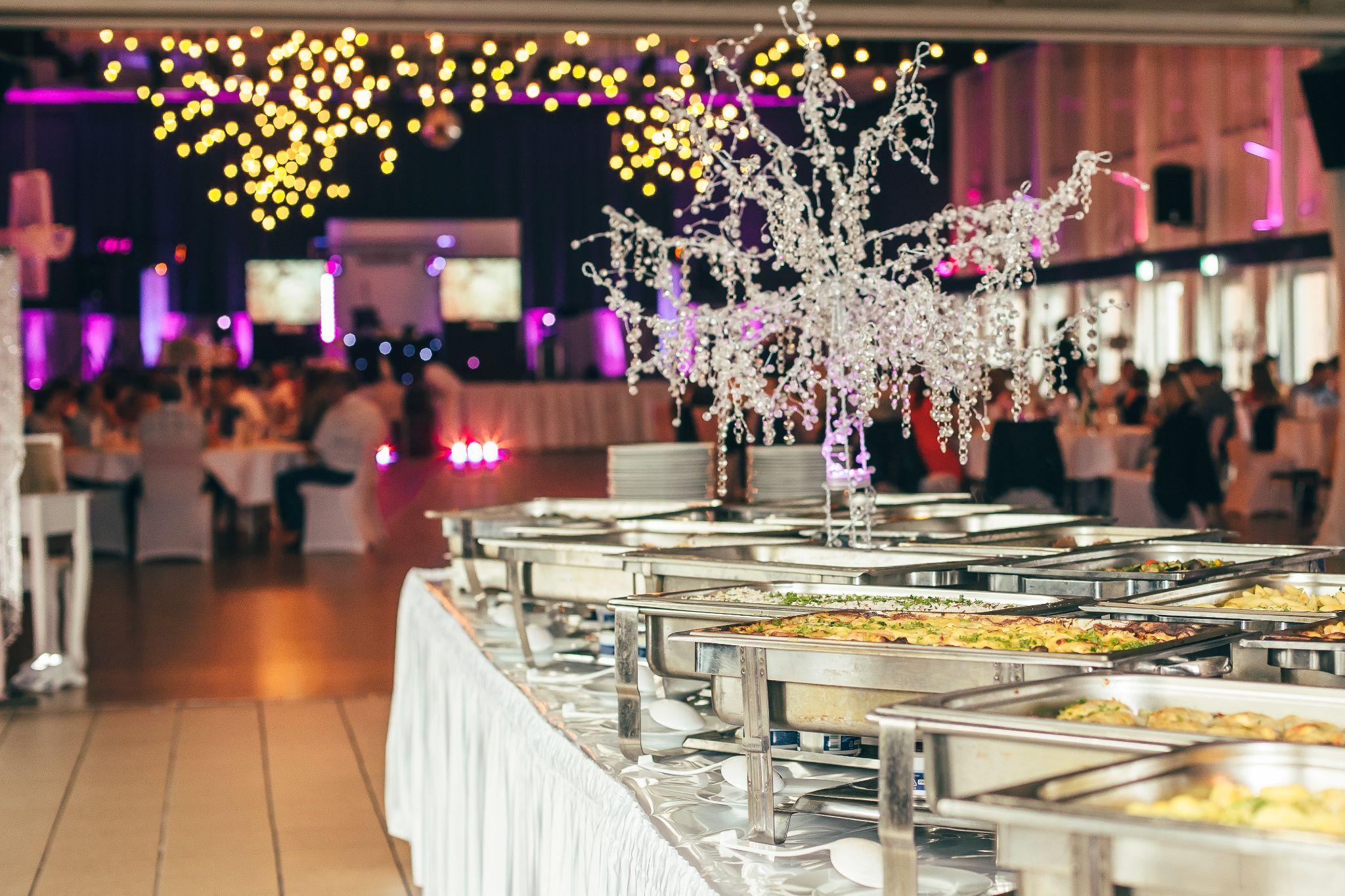 Elegant Seattle wedding buffet with warm lighting and gourmet entrées 