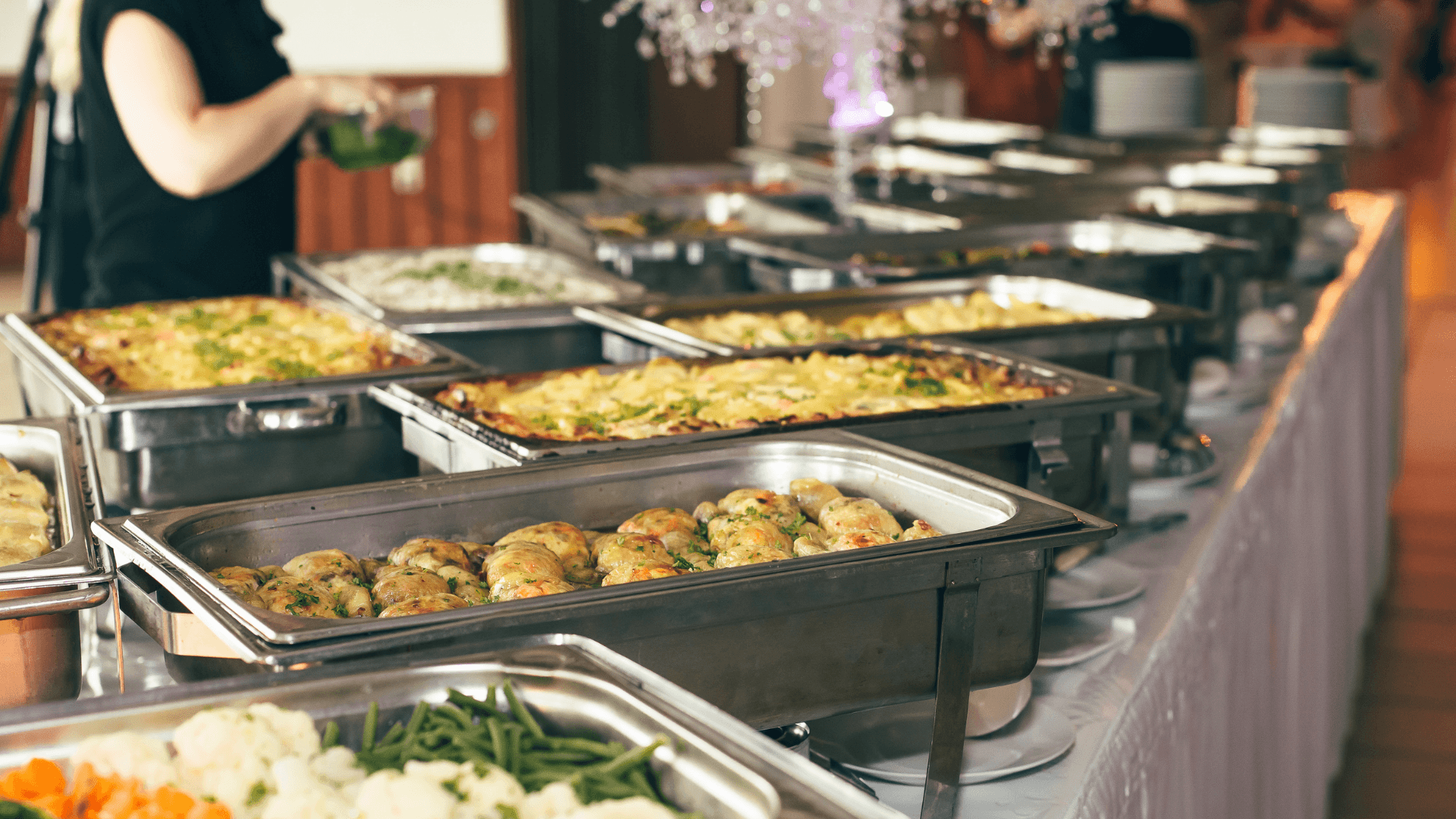 A platter of potatoes and vegetables at a catering event