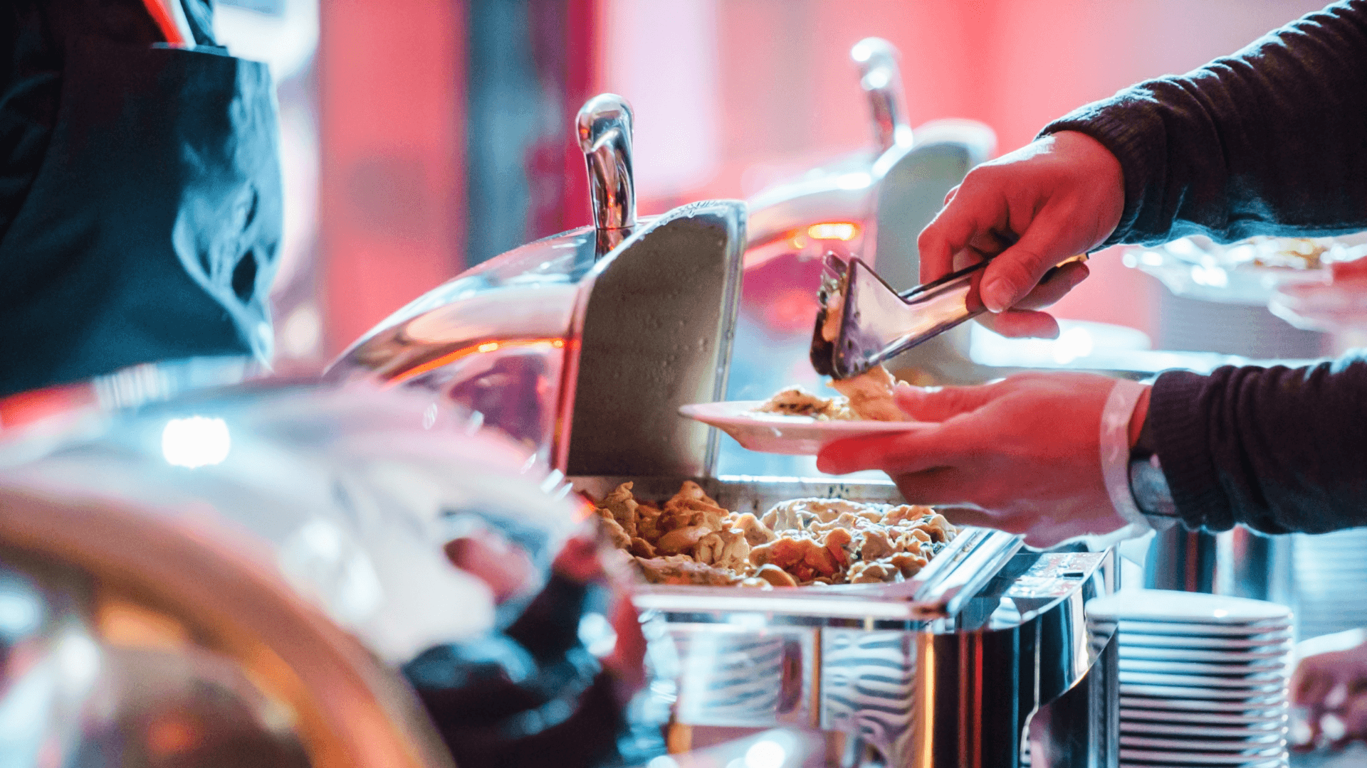 A man scooping meats and vegetables out of a pot